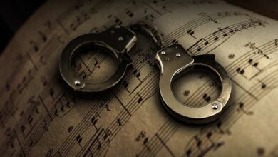 music notation sheet with handcuffs laying on top of it